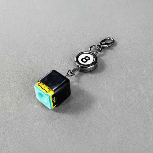 Chalk keyring on grey baize