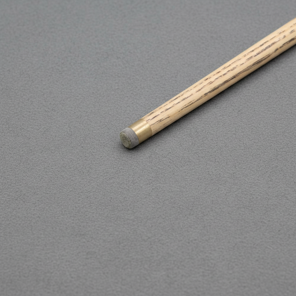 Ash cue tip on grey pool table cloth