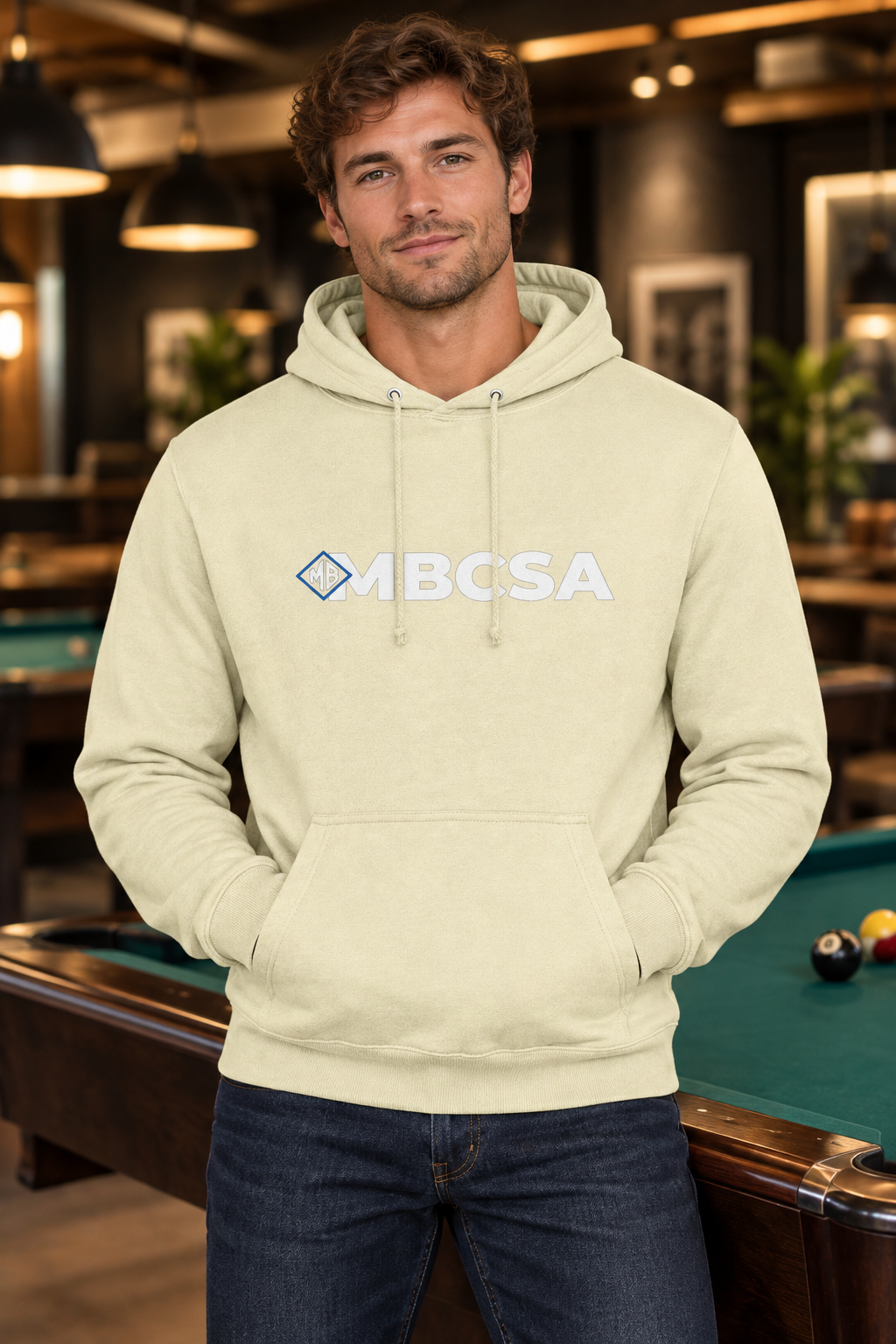 Model wearing the cream MBCSA hoodie